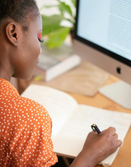 Woman Writing on Her Notebook